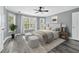 Primary bedroom with neutral decor, ceiling fan, and a bay window at 628 Warren Ave, Scottdale, GA 30079
