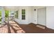 Inviting front porch with wood flooring, white trim, and views of the neighborhood at 628 Warren Ave, Scottdale, GA 30079