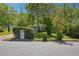 Street view of house with mature landscaping, an address marker, and a driveway at 877 Lee Andrews Se Ave, Atlanta, GA 30315