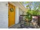 Inviting front porch with a yellow door, stylish decor, and seating area at 877 Lee Andrews Se Ave, Atlanta, GA 30315