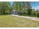 Charming home featuring well-maintained front yard, long driveway, and mature trees at 877 Lee Andrews Se Ave, Atlanta, GA 30315