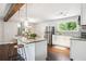 Modern kitchen with white cabinets, stainless steel appliances, granite countertops and an island with barstool seating at 877 Lee Andrews Se Ave, Atlanta, GA 30315