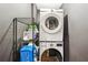 Convenient laundry area with stacked washer and dryer and shelving for storage at 877 Lee Andrews Se Ave, Atlanta, GA 30315