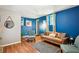 Comfortable living room with hardwood floors, stylish furniture, and bright blue accent wall at 877 Lee Andrews Se Ave, Atlanta, GA 30315