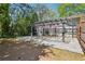 A covered patio area with hanging flowers, a gravel base, and privacy fencing at 877 Lee Andrews Se Ave, Atlanta, GA 30315