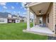 Cozy covered back patio with green lawn and view of adjacent homes, perfect for outdoor relaxation and entertaining at 681 Deer Springs Way, Loganville, GA 30052