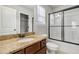Bathroom featuring granite countertop vanity, toilet and modern glass enclosed shower at 681 Deer Springs Way, Loganville, GA 30052