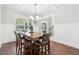 Bright dining area with wainscoting, decorative lighting, and wood floors at 681 Deer Springs Way, Loganville, GA 30052