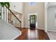 Bright foyer boasts soaring ceilings, wood floors, staircase, and an elegant entry door at 681 Deer Springs Way, Loganville, GA 30052