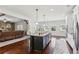 Open-concept kitchen featuring a center island, hardwood floors, and seamless transition to the living area at 681 Deer Springs Way, Loganville, GA 30052