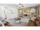 Cozy living room featuring a stone fireplace, comfortable seating, and a warm ambiance at 681 Deer Springs Way, Loganville, GA 30052