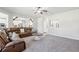 Spacious living room features plush carpet, neutral tones, and a comfortable, oversized leather sofa at 681 Deer Springs Way, Loganville, GA 30052