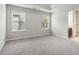Bright main bedroom with plush carpet, two windows, and en-suite bathroom access at 681 Deer Springs Way, Loganville, GA 30052