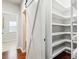 Spacious walk-in pantry with barn door, featuring ample shelving for organized storage at 681 Deer Springs Way, Loganville, GA 30052