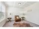 Cozy sitting room with coffered ceiling, accent chair, and neutral carpet at 681 Deer Springs Way, Loganville, GA 30052