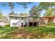 Charming home with a wooden deck overlooking a large, private backyard with mature trees at 4309 Gilbert Pl, Forest Park, GA 30297