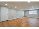 Finished basement with laminate flooring, recessed lighting and white trim at 4309 Gilbert Pl, Forest Park, GA 30297