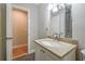 Bathroom featuring a granite countertop, white cabinets, and a mirror with modern lighting at 4309 Gilbert Pl, Forest Park, GA 30297