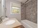 Bright bathroom with granite vanity top and tiled shower at 4309 Gilbert Pl, Forest Park, GA 30297