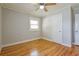 Bright bedroom with hardwood floors, ceiling fan, and fresh paint at 4309 Gilbert Pl, Forest Park, GA 30297
