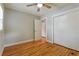 The bedroom offers original hardwood floors, neutral walls, and a closet with sliding doors at 4309 Gilbert Pl, Forest Park, GA 30297