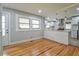 Bright dining area featuring hardwood floors, white trim, and stainless steel appliances in the adjacent kitchen at 4309 Gilbert Pl, Forest Park, GA 30297