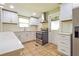 Modern kitchen with white cabinets, subway tile backsplash, stainless steel appliances, and tile flooring at 4309 Gilbert Pl, Forest Park, GA 30297