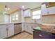 Modern kitchen featuring white cabinets, quartz countertops, subway tile backsplash, and stainless steel appliances at 4309 Gilbert Pl, Forest Park, GA 30297