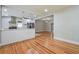 Open-concept kitchen featuring white cabinets, stainless steel appliances, and hardwood floors in dining area at 4309 Gilbert Pl, Forest Park, GA 30297