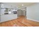 Hardwood living area flowing into modern kitchen with stainless steel appliances and island seating at 4309 Gilbert Pl, Forest Park, GA 30297
