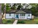 Charming home featuring a blue front door, white painted brick, and cozy front porch with seating at 2447 Hillside Ave, Decatur, GA 30032