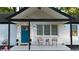 Inviting home exterior with a bright blue door, manicured landscaping, and cozy front porch seating at 2447 Hillside Ave, Decatur, GA 30032