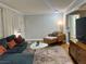Cozy living room featuring a plush couch, stylish furnishings, and warm hardwood floors at 2447 Hillside Ave, Decatur, GA 30032