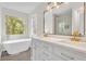 Elegant bathroom with a freestanding tub, double vanity, and large window offering natural light at 3905 Mill Glen Dr, Douglasville, GA 30135