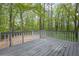 A wooden deck featuring a scenic view of the surrounding lush greenery and trees at 3905 Mill Glen Dr, Douglasville, GA 30135