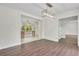Dining room open to kitchen with hardwood floors, trim, and modern light fixture at 3905 Mill Glen Dr, Douglasville, GA 30135