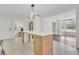 Bright and airy kitchen with white cabinets, island with seating, and views into other rooms at 3905 Mill Glen Dr, Douglasville, GA 30135