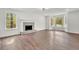 Open living room with large windows, hardwood floors, and a brick fireplace at 3905 Mill Glen Dr, Douglasville, GA 30135