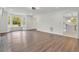 Inviting living room with hardwood floors, large windows, and an open doorway into a nearby kitchen at 3905 Mill Glen Dr, Douglasville, GA 30135
