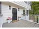 Cozy front porch featuring stylish lighting, potted pink flowers and painted wood at 3905 Mill Glen Dr, Douglasville, GA 30135