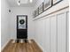 Hallway with light wood floors, a board and batten accent wall, and stylish decor at 401 Daffodil Dr, Temple, GA 30179