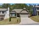 Inviting home with a landscaped front yard, a welcoming entrance, and a convenient two-car garage at 401 Daffodil Dr, Temple, GA 30179