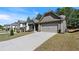 This beautiful home features a large driveway, a two-car garage, and well-maintained landscaping at 401 Daffodil Dr, Temple, GA 30179