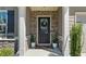 Inviting front entrance with decorative stone accents, a stylish door, and potted plants adding charm at 401 Daffodil Dr, Temple, GA 30179