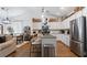 Bright, white kitchen features stainless steel appliances, granite countertops, and wood floors at 401 Daffodil Dr, Temple, GA 30179