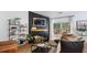 Cozy living room with a black accent wall, a fireplace, stylish decor, and comfortable seating at 401 Daffodil Dr, Temple, GA 30179