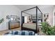 Spacious main bedroom features a four-poster bed, neutral decor, and ample natural light at 401 Daffodil Dr, Temple, GA 30179