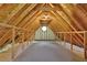 Spacious attic with wooden beams, rafters, and window that could be used for storage at 5830 Wills Wood Cir, Cumming, GA 30040