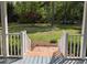 View from the porch stairs of a spacious backyard, offering a serene outdoor space at 5830 Wills Wood Cir, Cumming, GA 30040