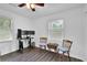 Bright bedroom with a ceiling fan, wood-look floors, and three-monitor desk setup at 5830 Wills Wood Cir, Cumming, GA 30040